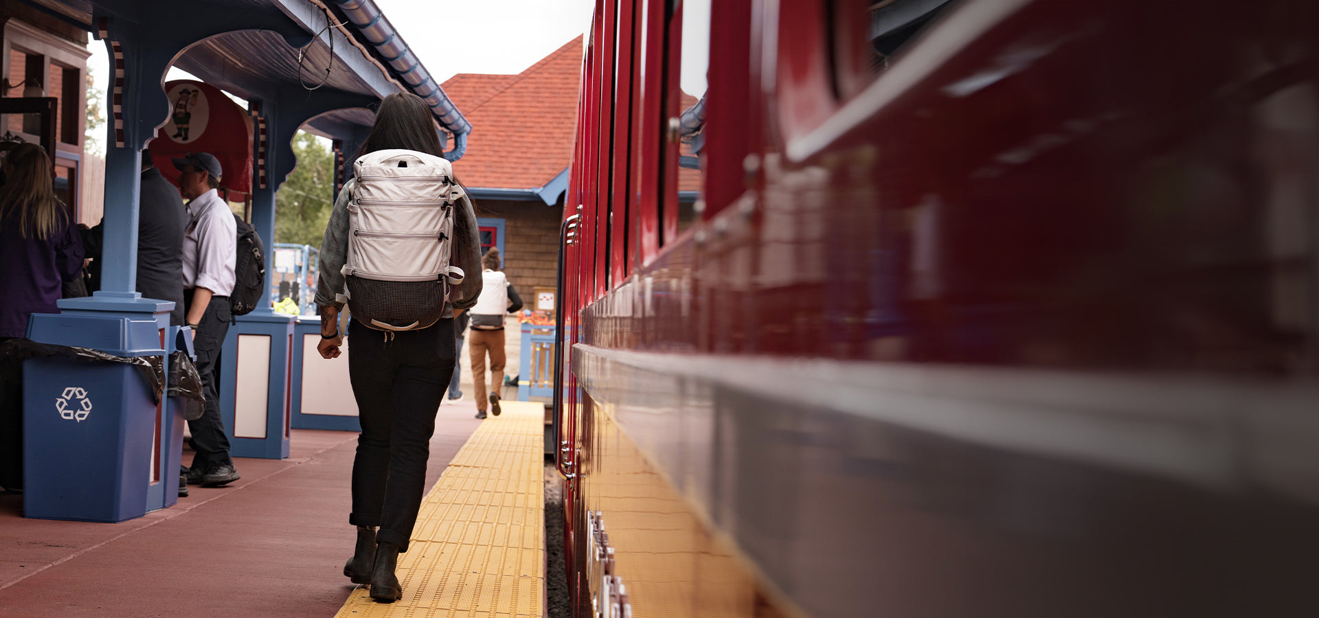 Woman walking on train platform wearing White SEG28